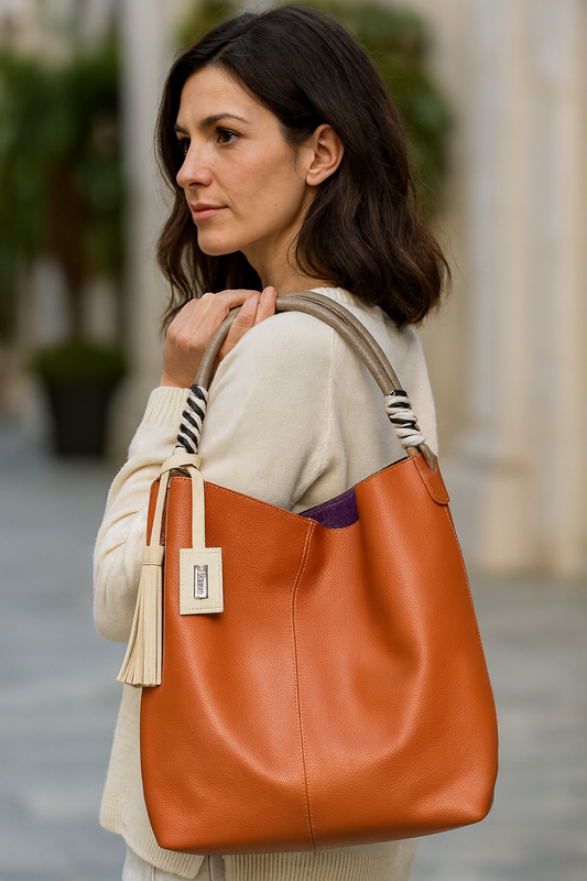 Mujer con bolso en cuero color jengibre al hombro.